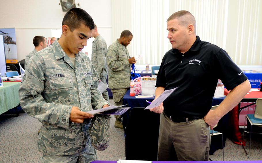 An airman speaks with a Grand Canyon University representative at an education fair at Vandenberg Air Force Base, Calif., Aug. 16, 2012.