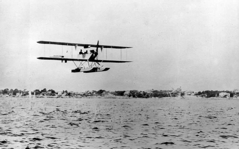 The Army's first tractor aircraft—the Burgess hydro Signal Corps No. 9—flies above the water at Salem, Mass., in July of 1912.
