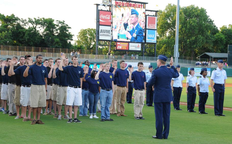 U.S. Air Force Lt. Gen. David S. Fadok delivers the oath of enlistment to new Air Force enlistees during Military Appreciation night at Riverwalk Stadiumin Montgomery, Ala., June 2, 2012. 