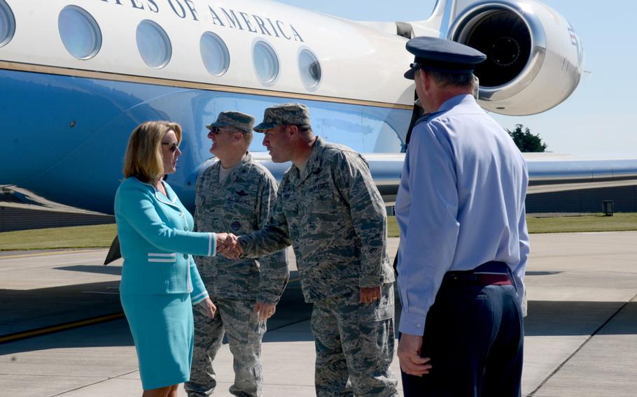 Secretary of the Air Force Deborah Lee James, left, shakes hands with U.S. Air Force Col. Kenneth T. Bibb Jr., 100th Air Refueling Wing commander, after arriving at RAF Mildenhall, England, on Wednesday, July 16, 2014. James is touring U.S. bases in England.