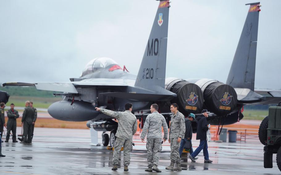Airmen stand by a F-15 Eagle during the Arctic Thunder Open House biennial event hosted by Joint Base Elmendorf-Richardson, Alaska, July 25, 2014.