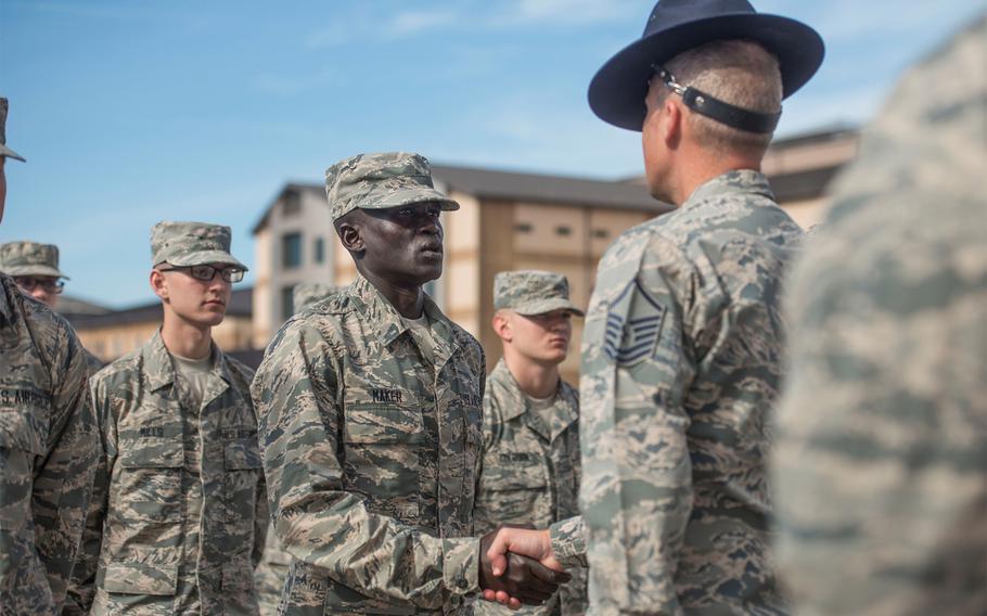 Gour Maker, a Basic Military Training trainee, receives an “Airman’s Coin” at the during a Feb. 1, 2018, ceremony at Joint Base San Antonio-Lackland, Texas. Maker was recognized as a selfless leader and motivator during his basic training.
