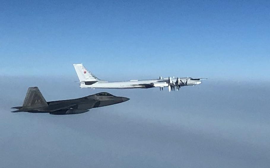 A North American Aerospace Defense Command F-22 fighter aircraft, left, intercepts a Russian Tu-95 bomber late Monday, Oct. 19, 2020.