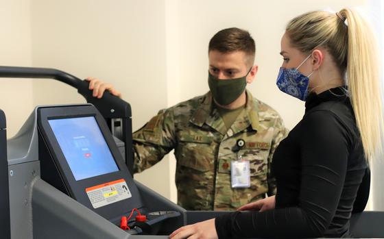 Maj. John Lax, a primary care and sports medicine physician with the 31st Medical Group at Aviano Air Base, Italy, watches as Air Force Staff Sgt. Katelyn Ramseygets ready to use the antigravity treadmill at the Comprehensive Operational Medicine for Battle Ready Airmen, or COBRA, clinic, at Aviano Air Base, Italy. Ramsey is being treated at the clinic, which is unique to Aviano, for a chronic knee injury. 
