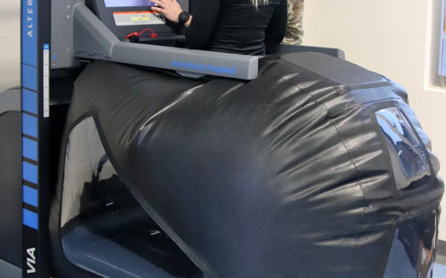Air Force Staff Sgt. Katelyn Ramsey, an aviation resource manager with the 57th Rescue Squadron, gets ready to use a treadmill that enables pain-free movement by reducing gravitational load and body weight, at the Comprehensive Operational Medicine for Battle Ready Airmen, or COBRA, clinic. 
