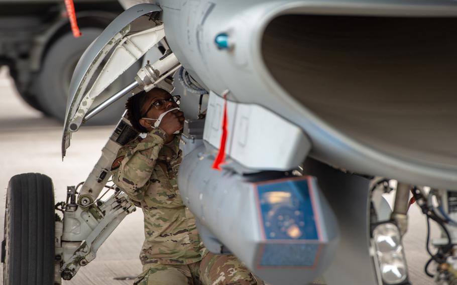 Senior Airman Courtney Farrar, a crew chief with the 52nd Aircraft Maintenance Squadron, performs a post-flight inspection on an F-16 Falcon during an agile combat employment exercise, March 22, 2021. The Spangdahlem-based airmen are at Ramstein to practice quickly deploying personnel and aircraft to forward locations.