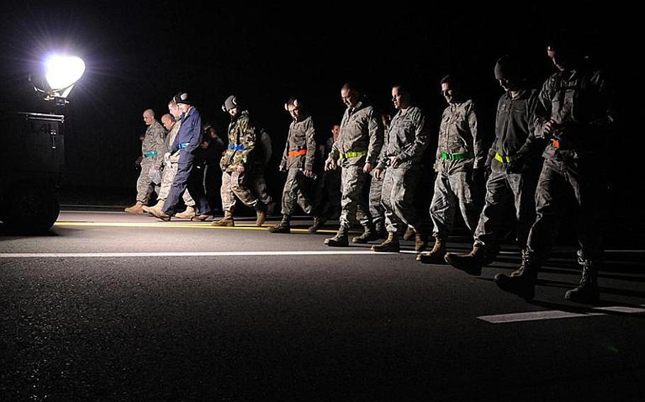 Airmen assigned to the 52nd Maintenance Group perform a foreign objects and debris inspection of a taxi-way March 19, 2011. 