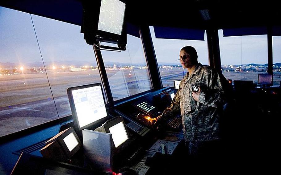 Senior Airman Nissean Johnson watches the flightline and sky for incoming and outgoing aircraft March 24, 2011, at Yokota Air Base, Japan. 