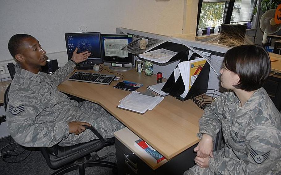 Staff Sgt. Andre Lewis, an outbound technician with the 786th Force Support Squadron at Ramstein Air Base, reviews a page on the Air Force's Military Personnel Data System on Sept. 26, 2012, with co-worker, Staff Sgt. Jennifer Kellar, the noncommissioned-officer-in-charge of retirements and separations. The Air Force said issues like pay could be impacted when system goes down in December for a major overhaul.