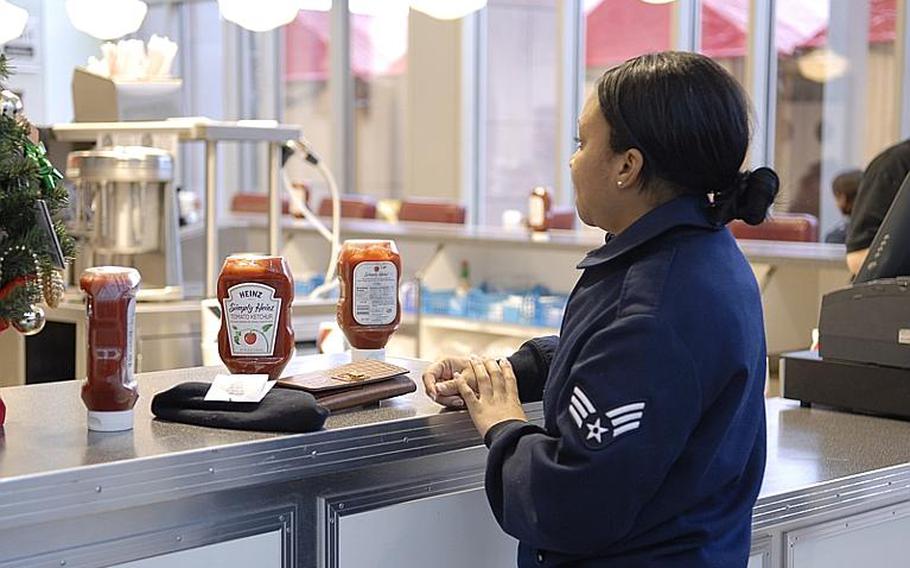 Senior Airman Sashia Euley waits for her lunch order at the food court at Ramstein Air Base, Germany, on Monday. She hopes she won&#39;t have to wear her dress blue uniform each week, after hearing that some commands are doing away with the "blues on Monday" requirement. Air Force Chief of Staff Mark Welsh III last week gave major command commanders the leeway to decide which uniform their airmen will wear in order to better perform their mission.