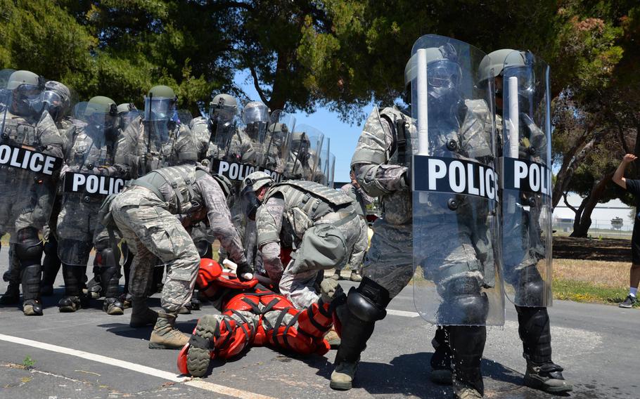 Members of the Air National Guard and the 129th Security Forces Squadron participate in confrontation management training at Moffett Federal Airfield, Calif., on June 7, 2015.The event was part of the 129th's annual training requirements.