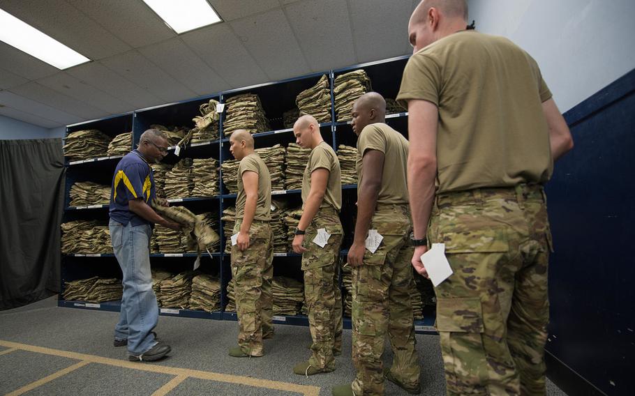 Cecil Harvey, the 502nd Logistics Readiness Squadron's lead supply technician, helps an Air Force basic military training trainee of the 326th Training Squadron during the initial issue of the first operational camouflage pattern uniform Oct. 2, 2019, at Joint Base San Antonio-Lackland, Texas.