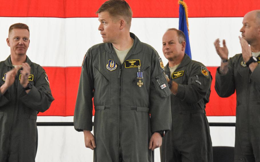Maj. John Tice, a flight commander with the 303rd Fighter Squadron, center, received the Distinguished Flying Cross and is recognized during a ceremony at Whiteman Air Force Base, Mo., in November of 2019. Tice was awarded for a mission he flew out of Kandahar Air Base, Afghanistan, in December 2010.