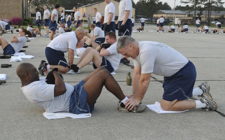 Senior Master Sgt. Johnny Gavin does situps during  physical training at Moody Air Force Base, Ga. The Air Force announced Thursday, March 19, 2020 that it is suspending physical fitness assessments because of the coronavirus outbreak.