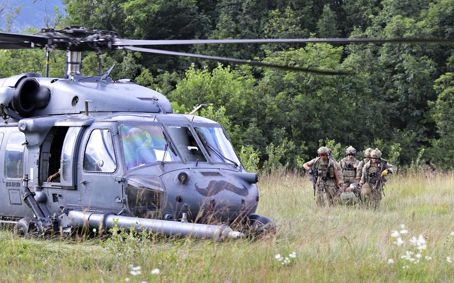Pararescuemen with the 57th Rescue Squadron, Aviano Air Base, Italy, attempt in an exercise to extract a downed pilot from a contested area during Operation Porcupine, held at an Italian army training area in the town of Osoppo, June 30, 2020.
