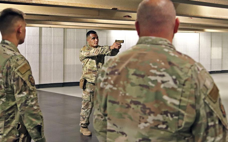 Staff Sgt. Enrique Salas, the Combat Arms Instructor for the 31st Security Forces Squadron at Aviano Air Base, Italy, instructs airmen on the proper engagement of their weapons, prior to a marksmanship qualification session with M4 carbines and the M18 handgun, July 14, 2020. The Air Force has chosen the M18 as its new service pistol, replacing the M9 Beretta, which has been in service for 30 years.