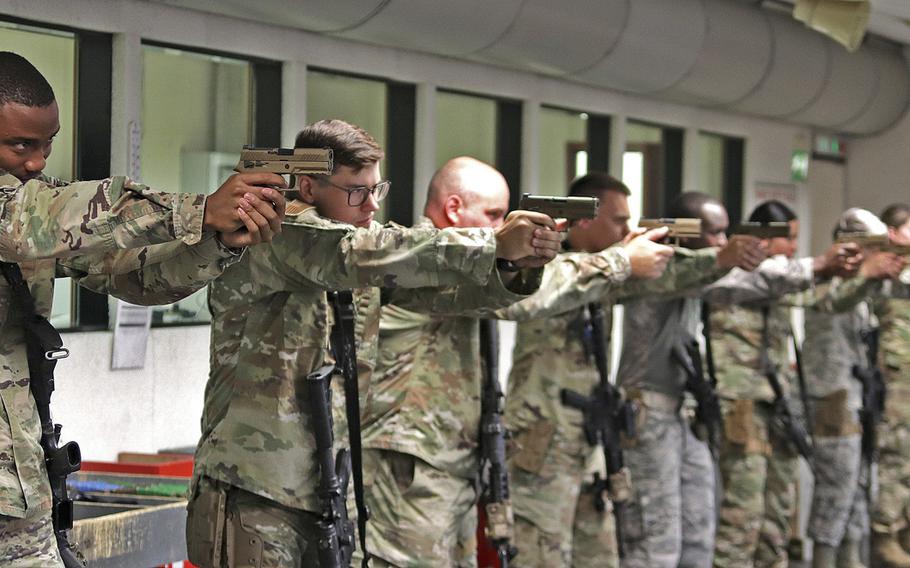 Security forces airmen assigned to the 31st Security Forces Squadron at Aviano practice drawing and aiming with their M18 service pistols, prior to a qualification session, July 14, 2020, at Aviano Air Base, Italy. The Air Force has chosen the M18 as its new service pistol, replacing the M9 Beretta, which has been in service for 30 years.