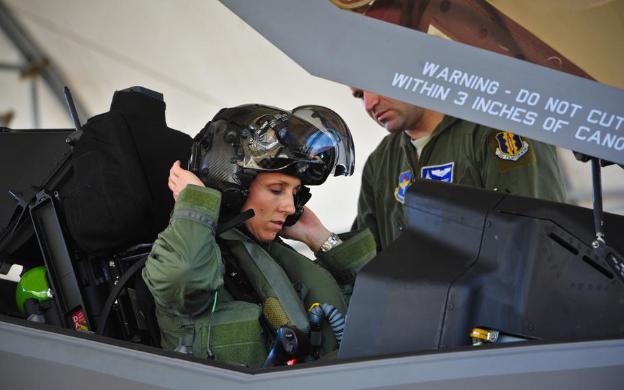 Lt. Col. Christine Mau, 33rd Operations Group deputy commander, puts on her helmet before taking her first flight in the F-35A on Eglin Air Force Base, Fla., May 2015. The Air Force is offering at least $100,000 in prize money to inventors who develop systems that allow female pilots to relieve themselves in flight.