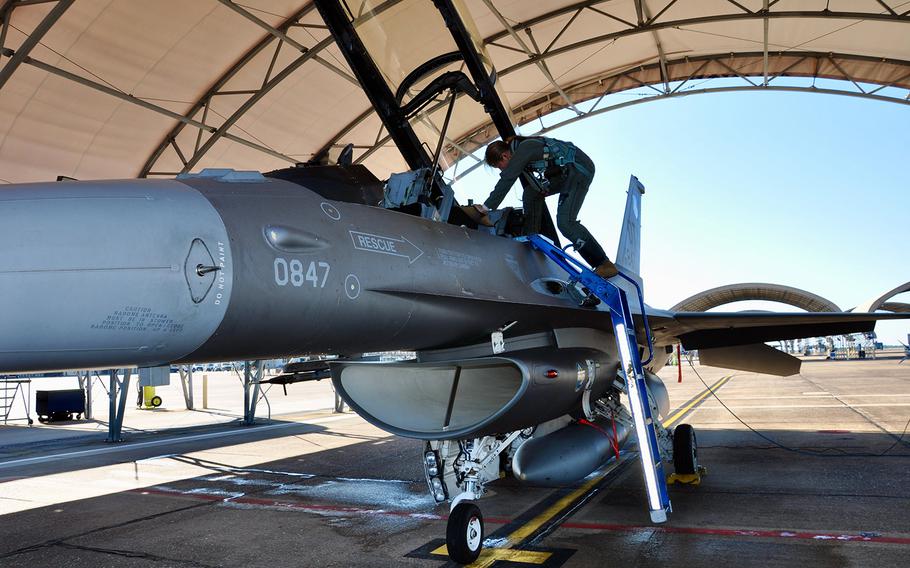 First Lt. Elizabeth Pennell, a T-38 pilot, steps into an F-16D Fighting Falcon at Eglin Air Force Base, Fla., while testing a modified version of the Air Force's G-suit in late October.
