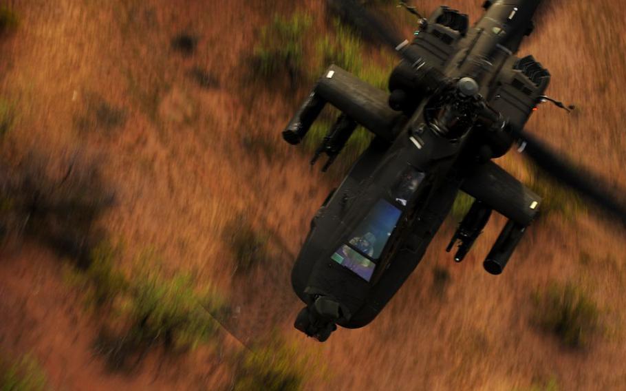 An AH-64 Apache helicopter soars over the deserts near Davis-Monthan Air Force Base, Tucson, Ariz., during a combat search-and-rescue exercise in April 2010.  The U.S. Army's Apache helicopter will be the first aircraft whose pilots will have the ability to control drones from their cockpit.