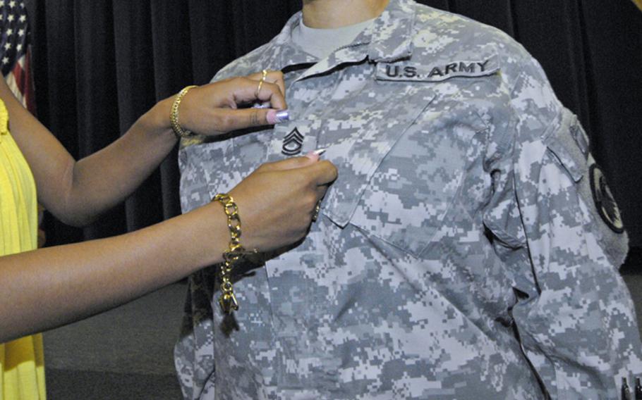 An Army NCO Academy graduate receives his E-7 stripes.




