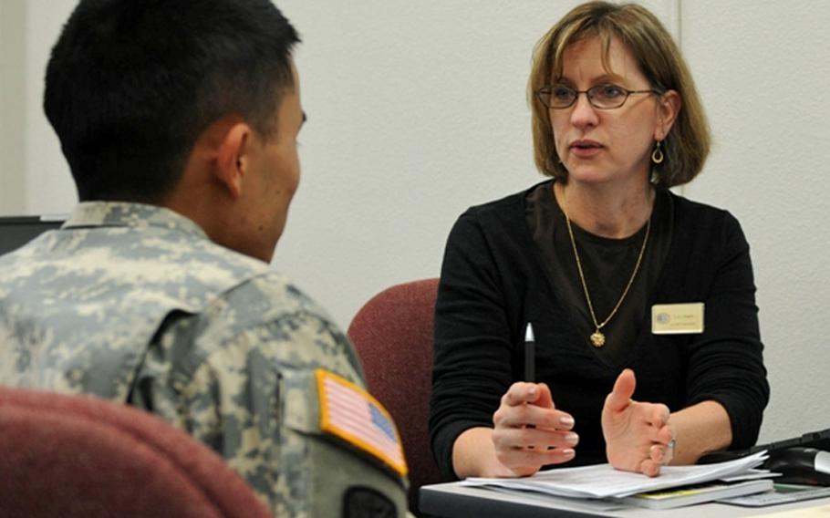 Lori Mann, right, an Army Career and Alumni Program counselor, offers career guidance to a soldier at the ACAP center at Joint Base Lewis-McChord, Wash.
