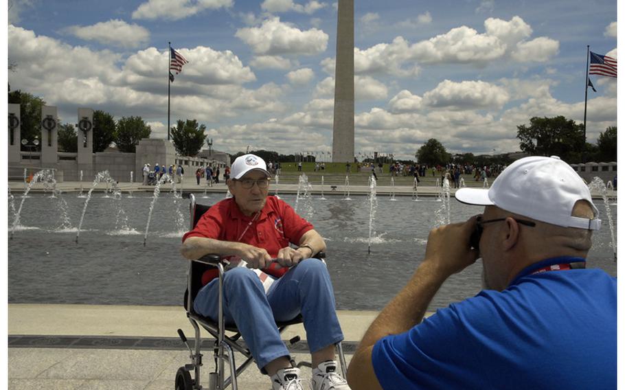 D-Day veteran Richard Main, 90, has his picture taken while visiting the WWII Memorial in Washington, D.C., on June 5, 2012.