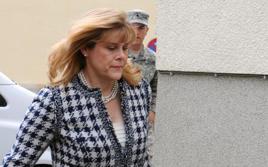 Kris Johnson, estranged wife of Col. James H. Johnson III, walks to the courtroom June 11, 2012, in Kaiserslautern, Germany, for the second day of court-martial proceedings against the former commander of the 173rd Airborne Brigade Combat Team. 