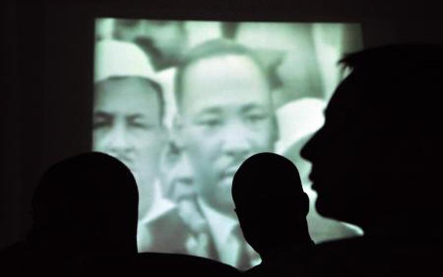 Soldiers watch a recording of Martin Luther King Jr.'s famous "I Have a Dream" speech at an observance at a U.S. base in Iraq in January 2010. The Pentagon has launched three major pushes in recent decades to crackdown on racist extremists, but the issue remains a problem, Reuters reports.