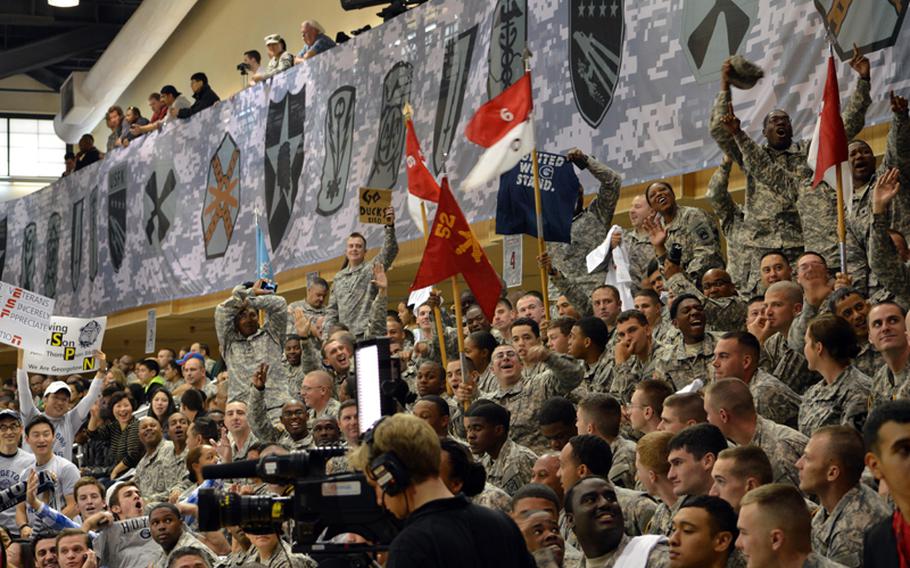 U.S. servicemembers cheer during the 2013 Armed Forces Classic basketball game, held at the Camp Humphreys Community Fitness Center in South Korea on Saturday, Nov. 9, 2013. Oregon went on to beat Georgetown 82-75. The televised game was part of ESPN's Veterans Week, meant to honor the U.S. military.