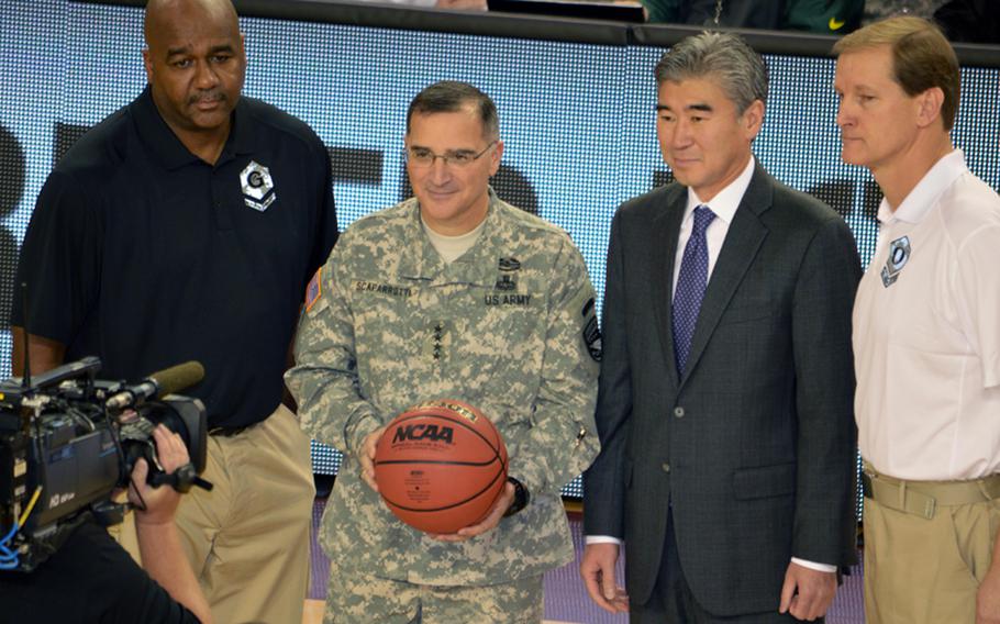 Gen. Curtis M. Scaparrotti, United Nations Command, Combined Forces Command and U.S. Forces Korea commander, and Sung Kim, U.S. ambassador to South Korea, hold the game ball at the 2013 Armed Forces Classic basketball game at Camp Humphreys Community Fitness Center in South Korea on Saturday, Nov. 9, 2013.