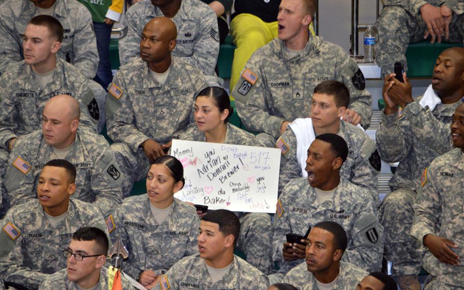 A soldier holds a game sign during the 2013 Armed Forces Classic basketball game at Camp Humphreys Community Fitness Center in South Korea on Saturday, Nov. 9, 2013.