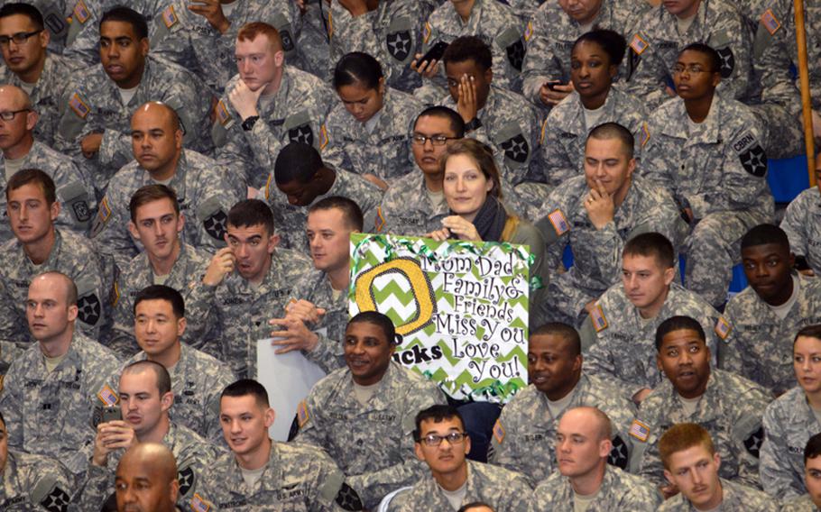 An Oregon fan holds a game sign during the 2013 Armed Forces Classic basketball game at Camp Humphreys Community Fitness Center in South Korea on Saturday, Nov. 9, 2013.