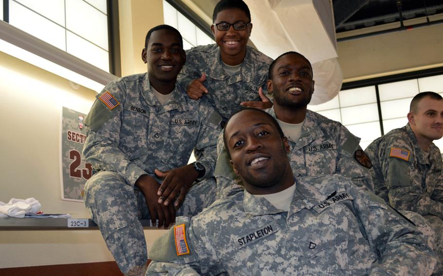 U.S. soldiers from Camp Red Cloud Headquarters and Headquarters Company enjoy the 2013 Armed Forces Classic NCAA basketball game at Camp Humphreys, South Korea, on Saturday, Nov. 9, 2013.