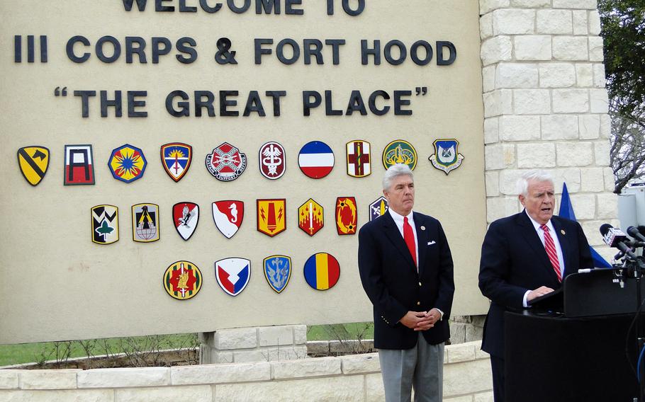 U.S. Congressmen Roger Williams, left, and John Carter, right, speak to the press in front of Fort Hood's gate on Saturday. Williams and Carter met with victims of the mass shooting, and said they were impressed with their resilience and bravery.