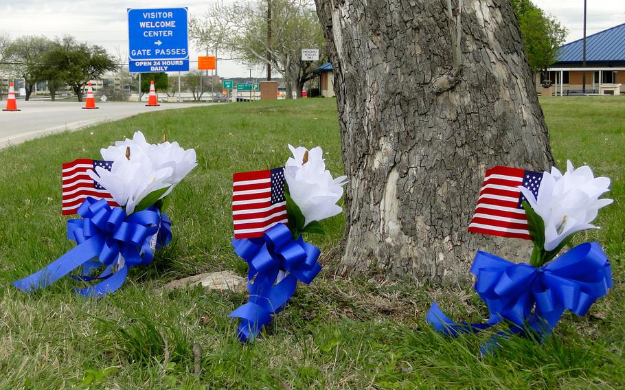 Small memorial flags have been placed near Fort Hood's visitors center and main gate, after the mass shooting at the post Wednesday left four soldiers, including the suspected shooter, dead.