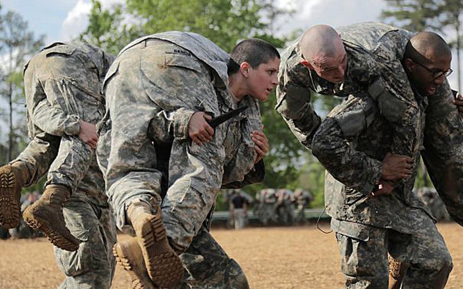 Army Capt. Kristen Griest carries a soldier during Ranger School at Fort Benning, Ga. She was one of the first two women to make it through the 62-day leadership course. The Army announced Friday, April 15, 2016, the first 22 women to be commissioned as infantry and armor officers.