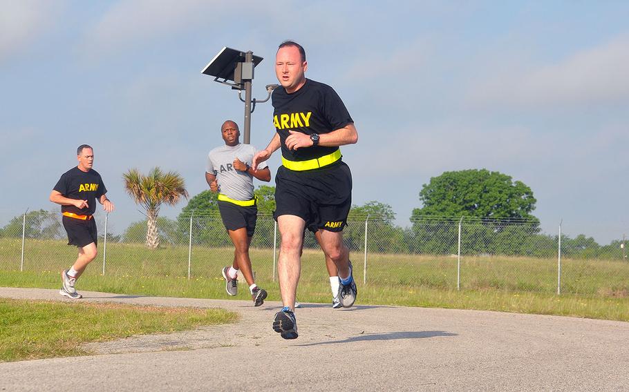 Soldiers with the Army Reserve's 75th Training Command Headquarters Company participate in a timed, two-mile run as part of a semi-annual test of physical fitness in Houston, Texas on Friday, April 21, 2017.