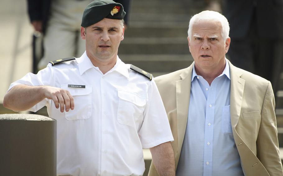 Maj. Mathew Golsteyn leaves the Fort Bragg courtroom facility with his civilian lawyer, Phillip Stackhouse, right, after a hearing on Thursday, June 27, 2019.