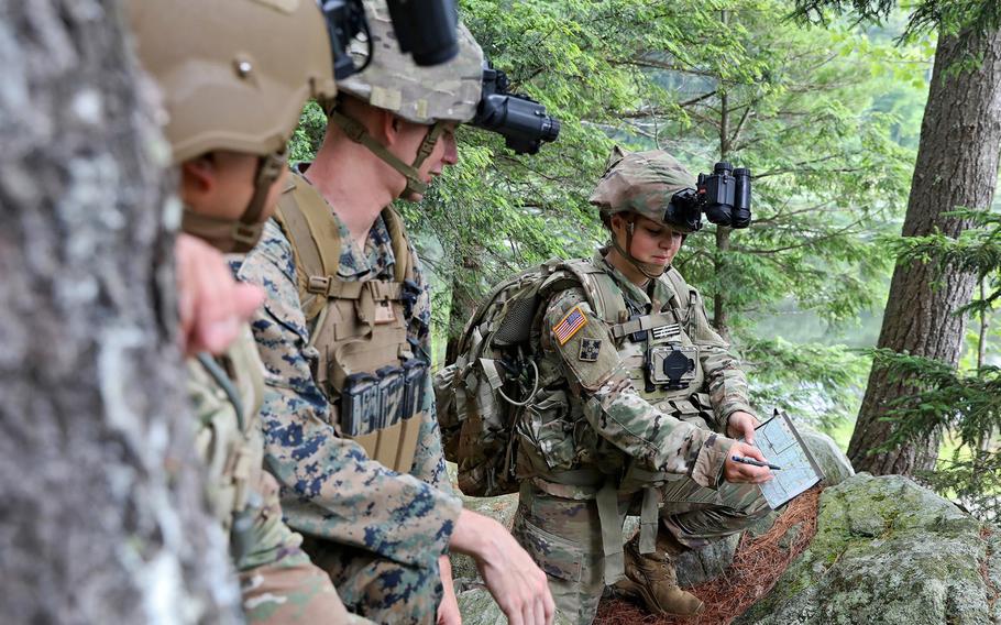 New Hampshire Army National Guard Sgt. Gabrielle Hurd shows her team the route they will take before embarking on an overnight hike to the summit of Mount Monadnock, New Hampshire, during an Enhanced Night Vision Goggle-Binocular training event, July 10-12, 2019.