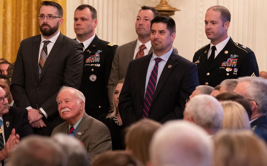 Army Master Sgt. Matthew O. Williams, right, and other soldiers who fought in the battle for Shok Valley in Afghanistan on April 6, 2008, stand as President Donald Trump calls their name during an October, 2018 ceremony presenting the Medal of Honor for the group's medic, former Staff Sgt. Ronald J. Shurer II. Williams will also receive the nation's highest military honor, in a White House ceremony on Oct. 30, 2019.