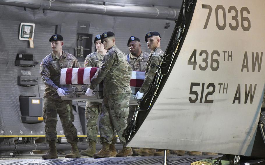 An Army carry team moves a transfer case containing the remains of Spc. Antonio I. Moore, Tuesday, Jan. 28, 2020, at Dover Air Force Base, Del.