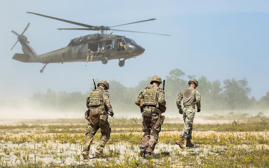 Advisors from 1st Security Force Assistance Brigade, approach a A UH-60L Black Hawk for sling load transportation during the Advisor Forge training exercise at Fort Benning, Ga., on August 13, 2019.