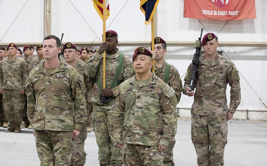 From front left, U.S. Army Col. Andrew O. Saslav, commander of the 1st Brigade Combat Team, and Command Sgt. Maj. Thinh T. Huynh, the departing senior enlisted adviser of 1st Battalion, 504th Parachute Infantry Regiment, 82nd Airborne Division, participate with with soldiers during a change-of-responsibility ceremony in the Central Command area of responsibility on Jan 16, 2020.
