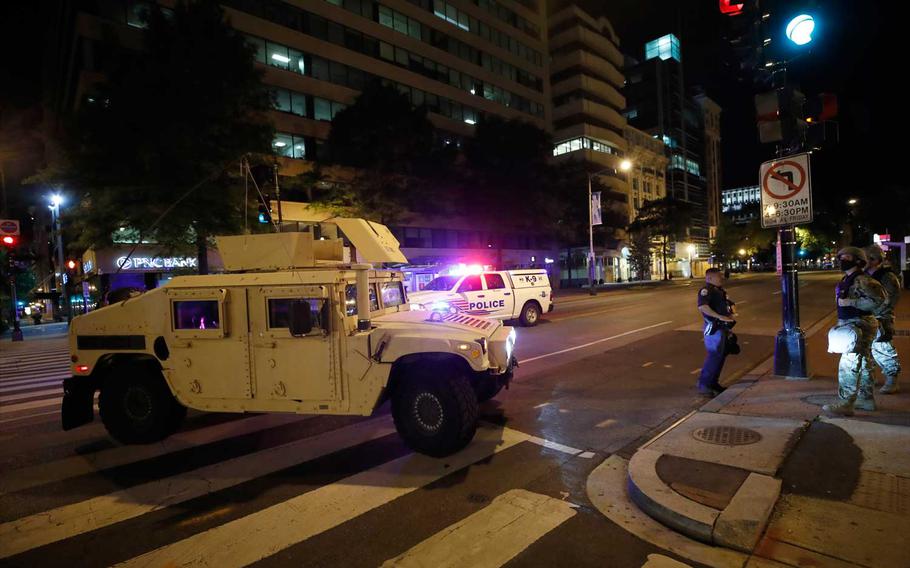 A military Humvee blocks an intersection along K Street in downtown Washington as demonstrators protest the death of George Floyd, Monday, June 1, 2020, in Washington. Floyd died after being restrained by Minneapolis police officers. 