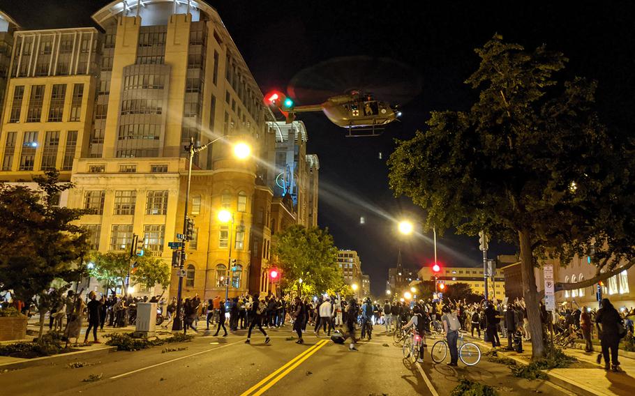 A Lakota helicopter from the D.C. Army National Guard hovers over an intersection in downtown Washington on June 1.