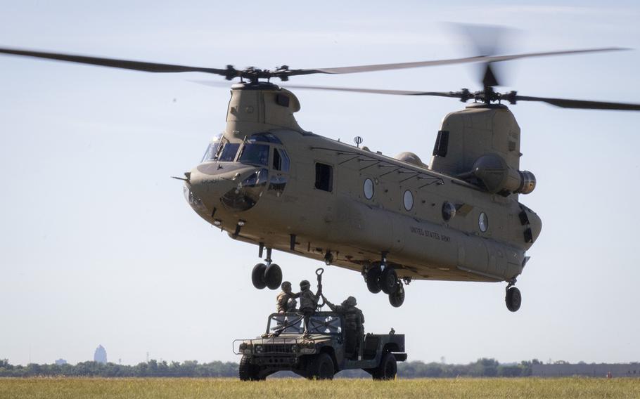 Soldiers with the 3662nd General Support Maintenance Company, North Dakota National Guard, conduct sling-load training, hooking a Humvee onto a CH-47F Chinook helicopter operated by pilots with Company B, 2nd Battalion, 211th General Support Aviation Battalion with Iowa Army National Guard Support Facility 3, at Camp Dodge, in Johnston, Iowa, on July 22, 2020. 