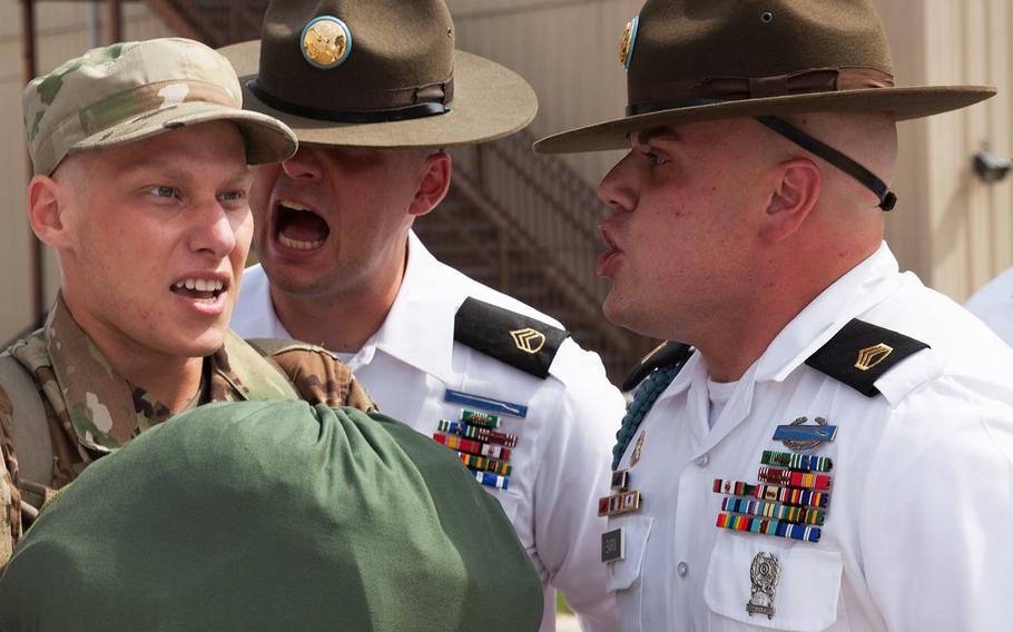 U.S. Army Drill Sergeants assigned to Foxtrot 1st Battalion 34th Infantry Regiment participate in the "Shark Attack," or fear, stage of the discipline process, as trainees arrive on the First day of Basic Combat Training on June 12, 2017 at Fort Jackson, S.C.