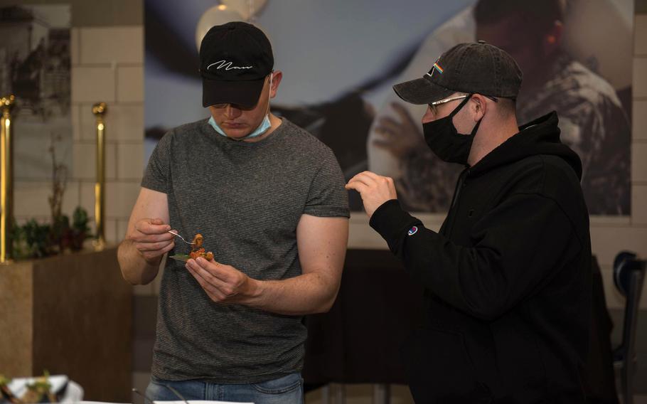 Pfc. Christopher Vandonsel, left, and Pfc. Michael Corrales, 303rd Military Intelligence Battalion, give their opinions on the food at the inaugural Taste Fest event at the Always Ready Warrior Restaurant at Fort Hood, Texas, March 12, 2021.

