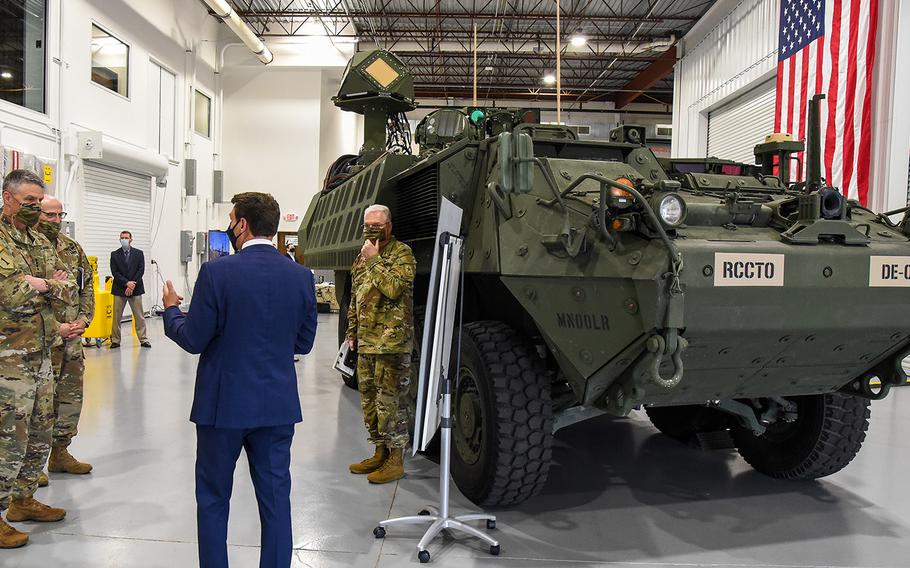 Gen. Joseph Martin, the vice chief of the Army, left, views the first prototype of the service's new laser weapon, the Directed Energy Maneuver Short-Range Air Defense system, or DE M-SHORAD, during a visit to Huntsville, Ala., and Redstone Arsenal on April 29, 2021. 